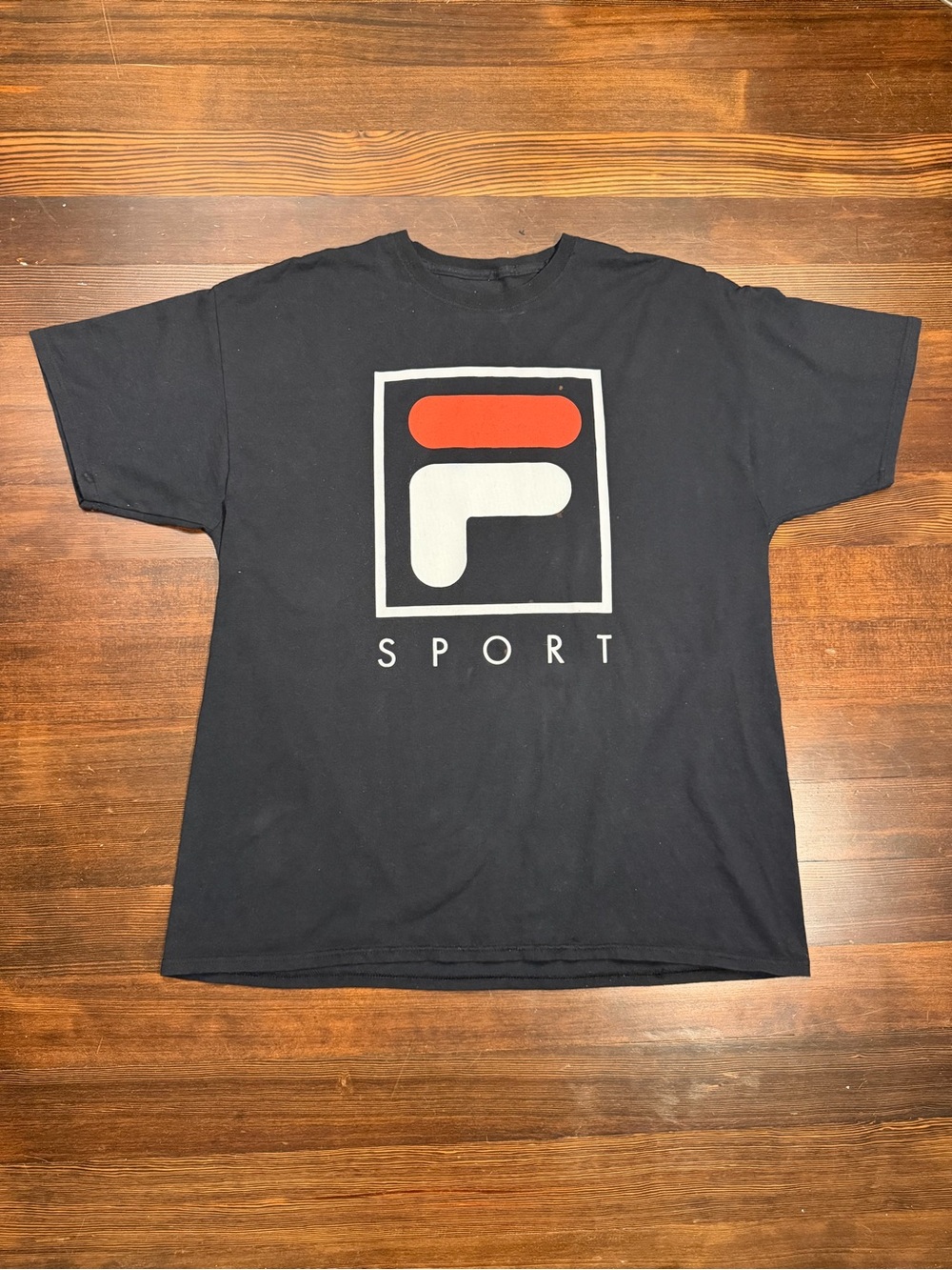 Vintage-inspired FILA Sport black graphic tee featuring the iconic oversized red